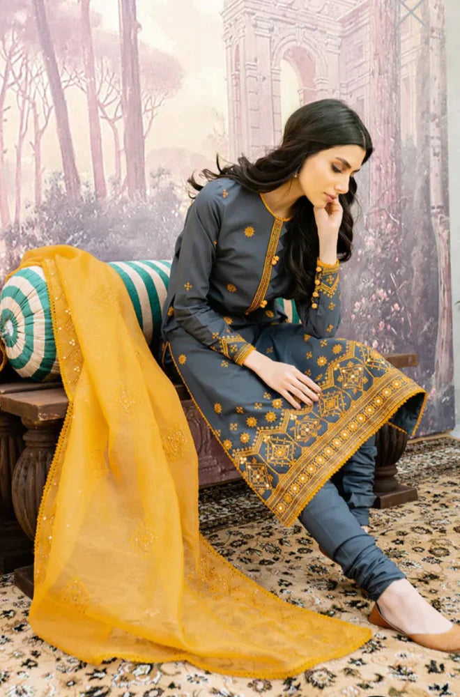 Pakistani model in lawn and cambric fabric suit in gold and navy blue colour