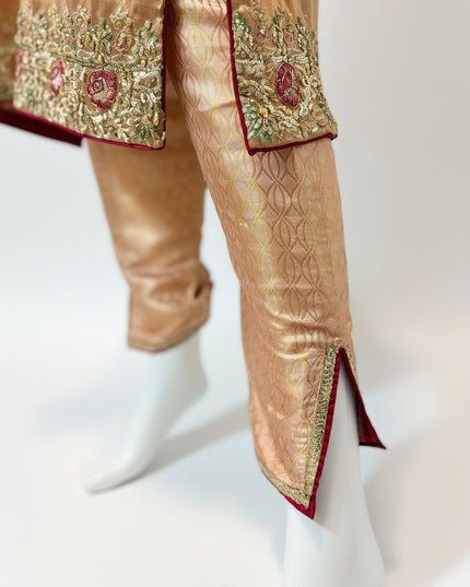 Traditional outfit with embroidered top and pants on a white background