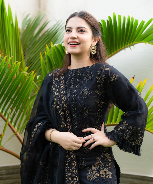Pakistani model Dana Neer in a black designer dress with gold embroidery