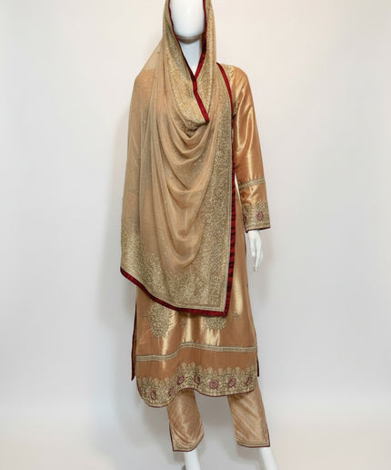 Traditional outfit with embroidered gold dress and matching dupatta on a mannequin against a white background