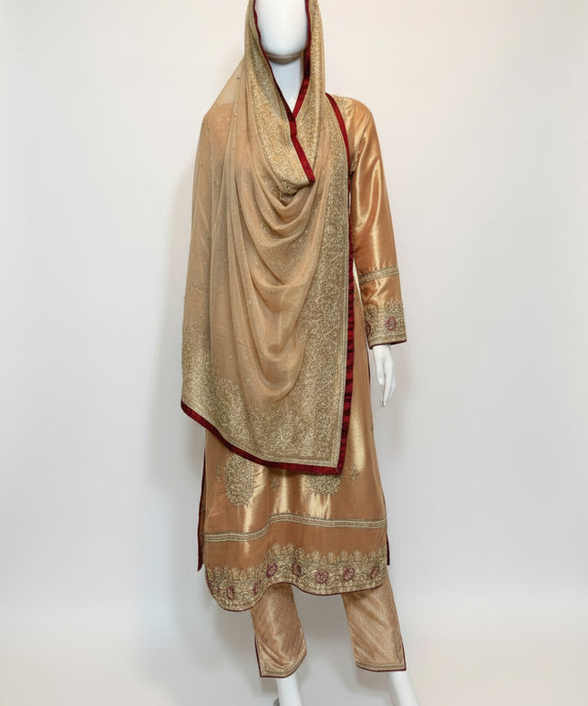 Traditional outfit with embroidered gold dress and matching dupatta on a mannequin against a white background