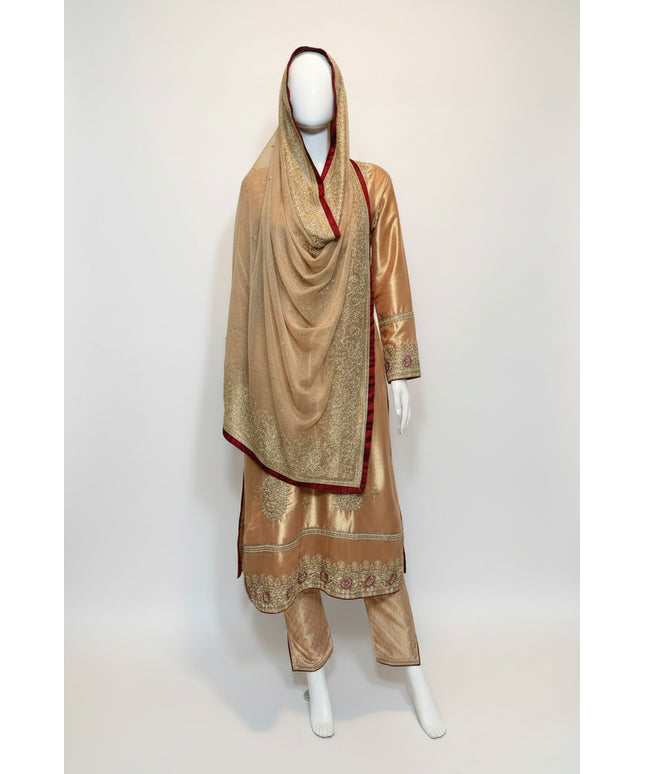 Traditional outfit with embroidered gold dress and matching dupatta on a mannequin against a white background