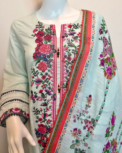 Embroidered traditional outfit on a mannequin with a plain background