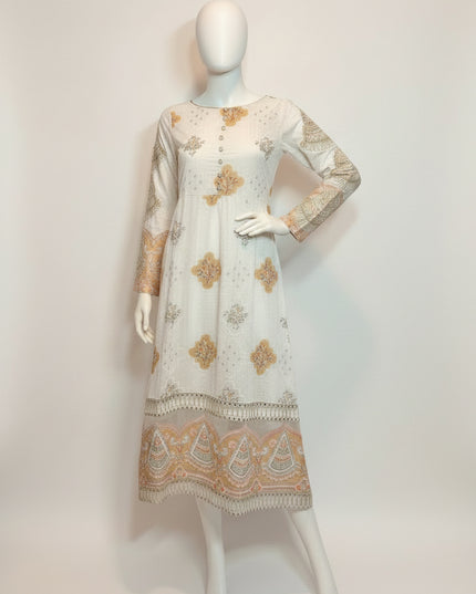 White dress with floral patterns on a mannequin against a plain background