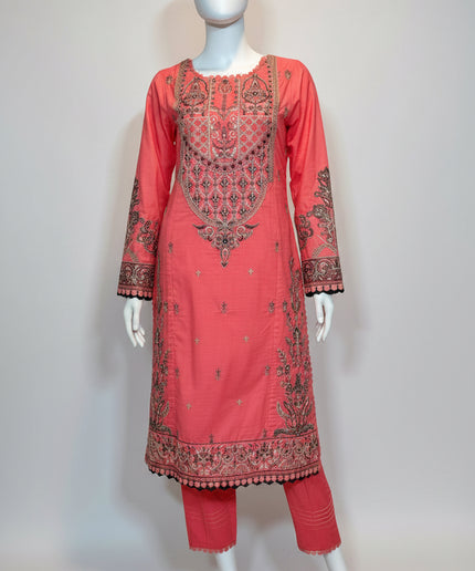 Coral pink embroidered traditional outfit on a mannequin against a white background