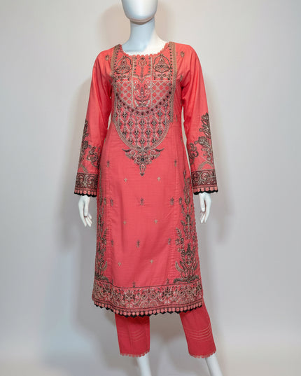 Coral pink embroidered traditional outfit on a mannequin against a white background