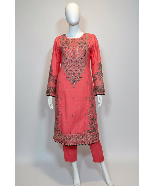 Coral pink embroidered traditional outfit on a mannequin against a white background