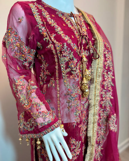 Maroon embroidered traditional outfit on a mannequin against a neutral background