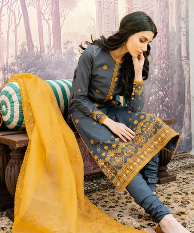 Pakistani model in lawn and cambric fabric suit in gold and navy blue colour