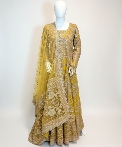 Yellow embroidered traditional outfit on a mannequin against a white background