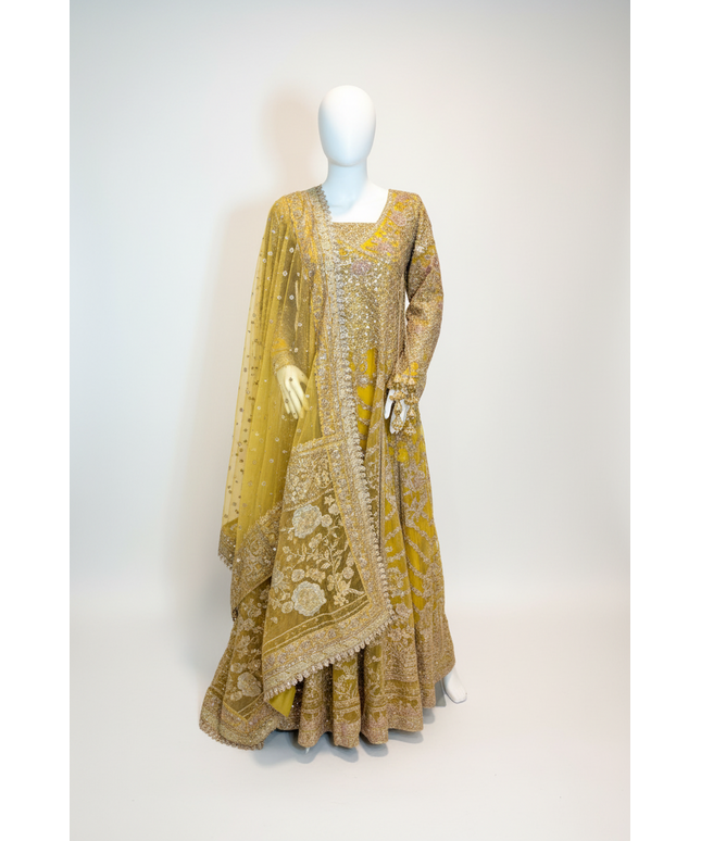 Yellow embroidered traditional outfit on a mannequin against a white background