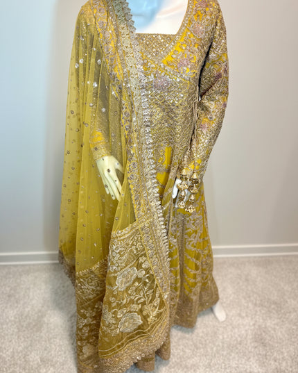 Traditional embroidered outfit on a mannequin against a plain background
