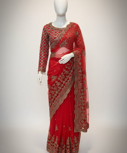 Red saree with gold embroidery on a mannequin against a white background