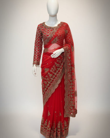 Red saree with gold embroidery on a mannequin against a white background