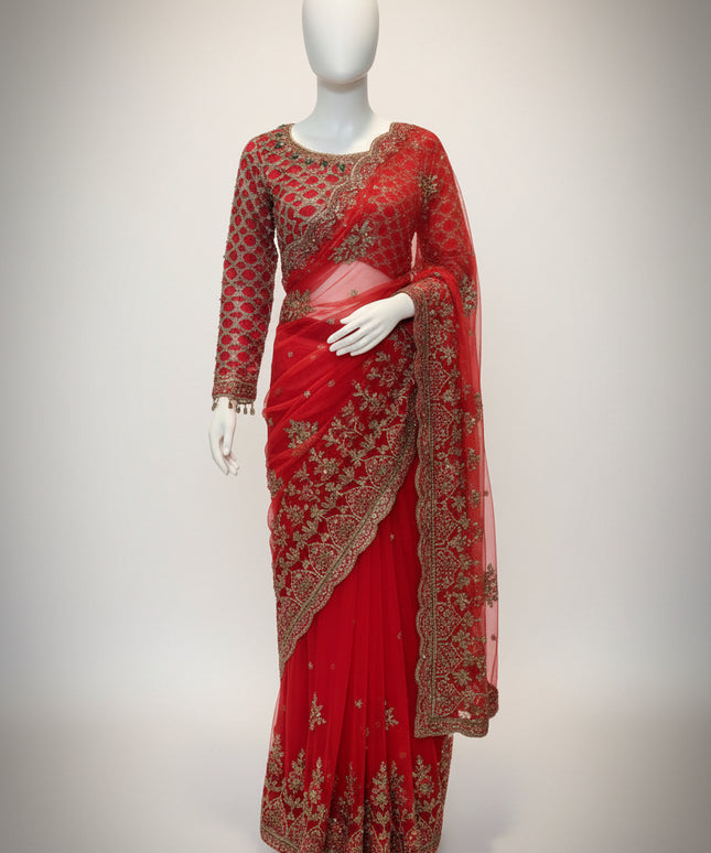 Red saree with gold embroidery on a mannequin against a white background
