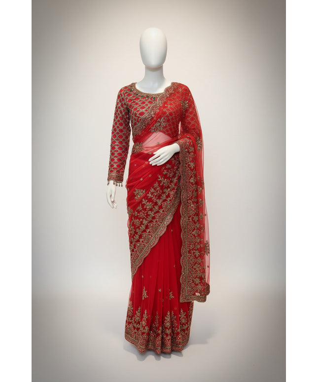 Red saree with gold embroidery on a mannequin against a white background