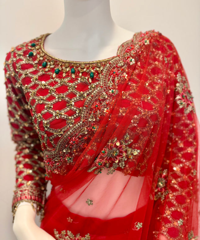 Red saree with gold embroidery on a mannequin against a white background