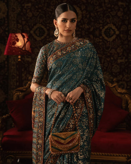 Woman in a traditional saree with intricate patterns in a decorative setting