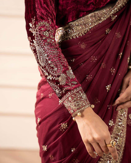 Maroon saree with gold embroidery and a close-up of a hand wearing a ring.