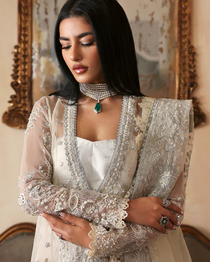 Woman wearing a traditional embroidered outfit with a decorative background
